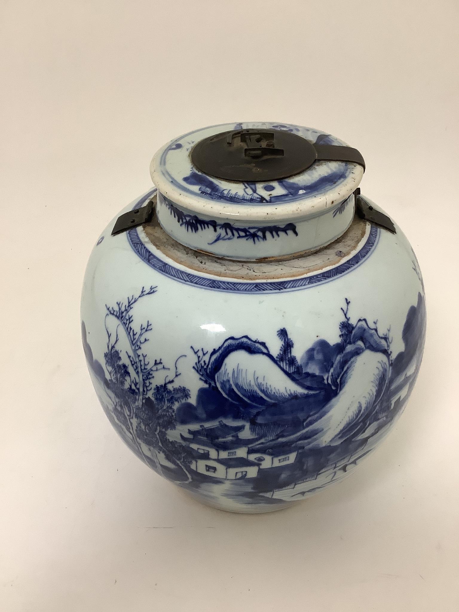 A Chinese blue and white jar and cover, Kangxi period (1662-1722), 23cm high, metal fittings attached to shoulder, Cover repaired and not the best fit